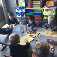 Children drawing at a table