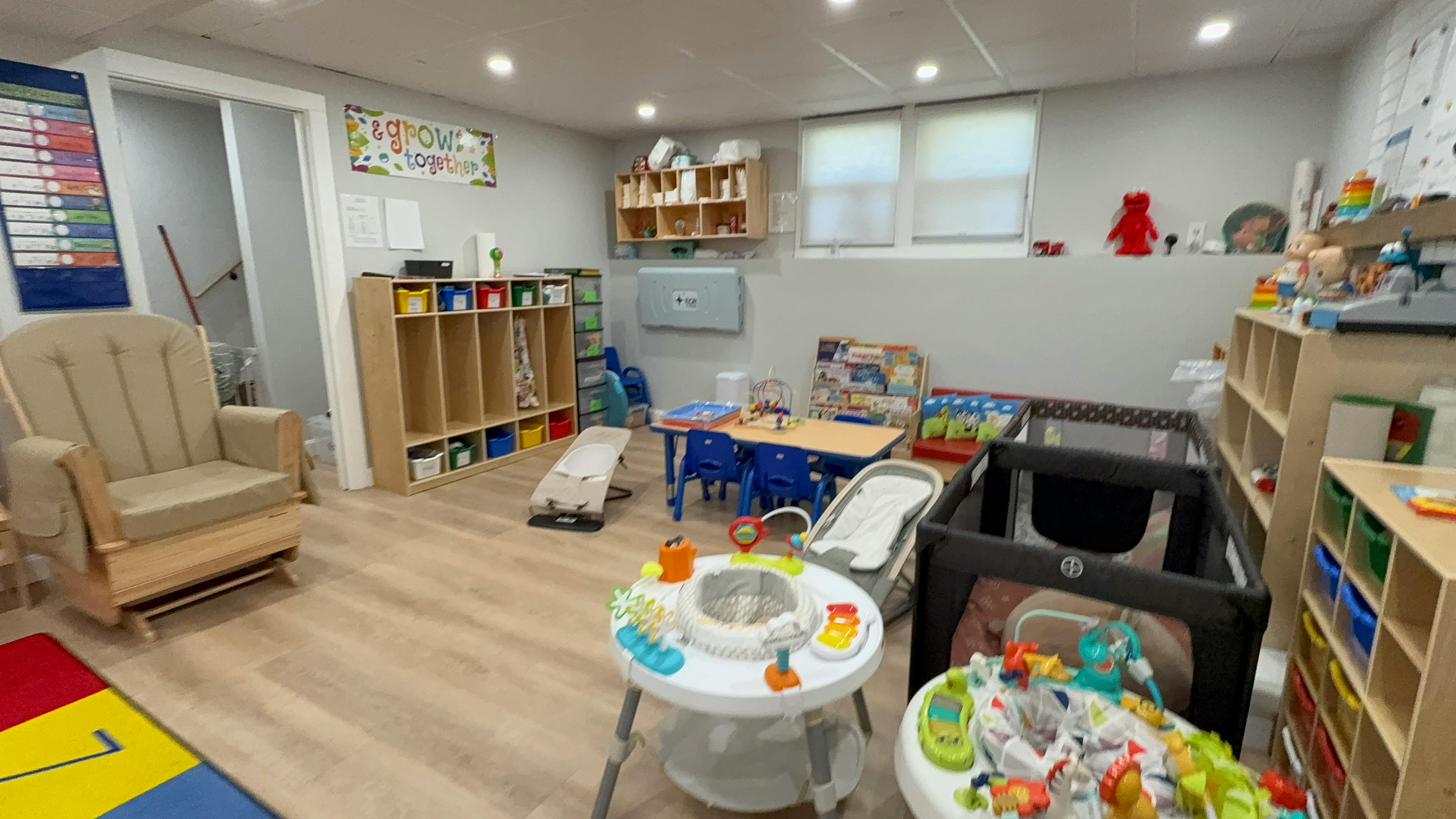 Childcare room with play equipment furniture and toys