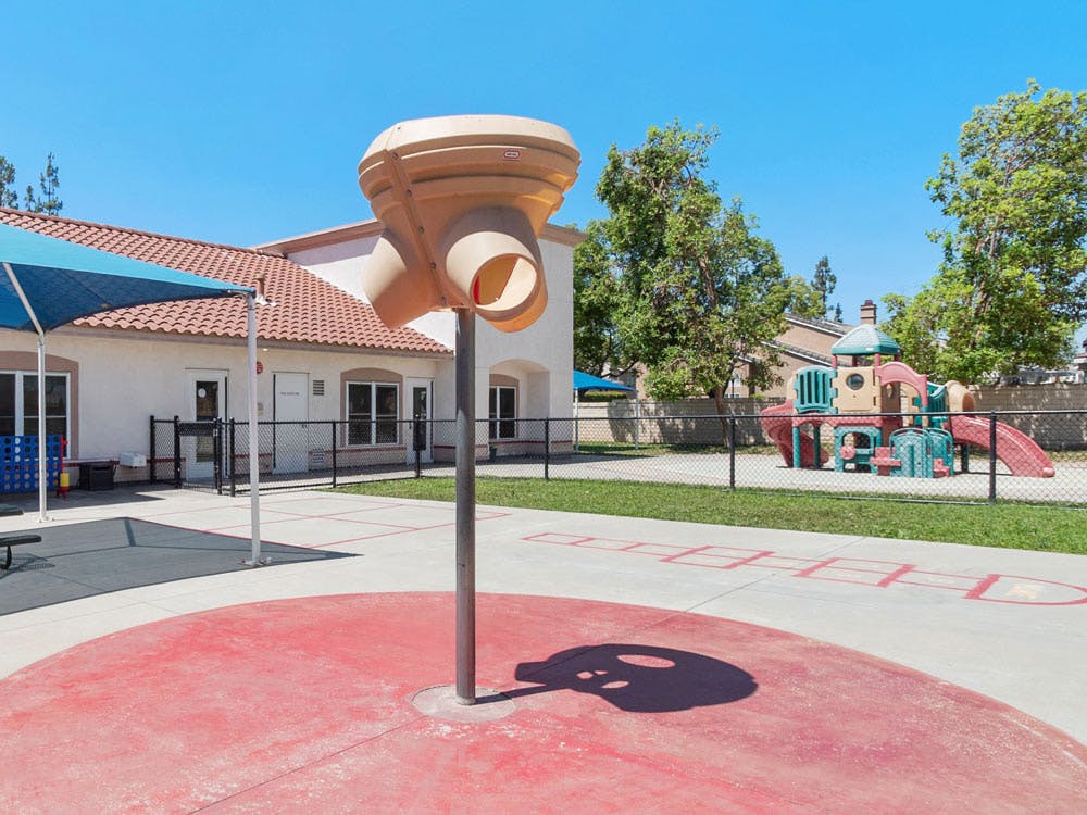 Playground area with a water feature and climbing structure