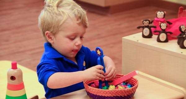 Child playing with toys in a basket