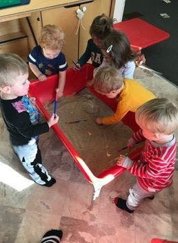 Children playing with sand and water in a sensory table