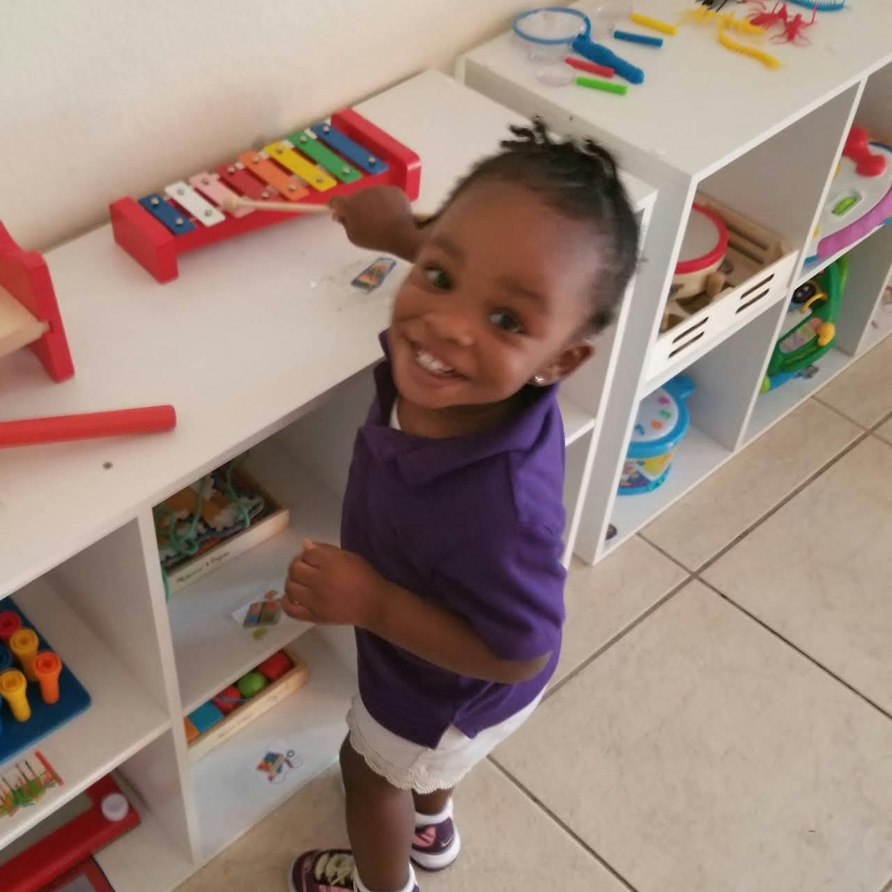 Child playing a toy xylophone