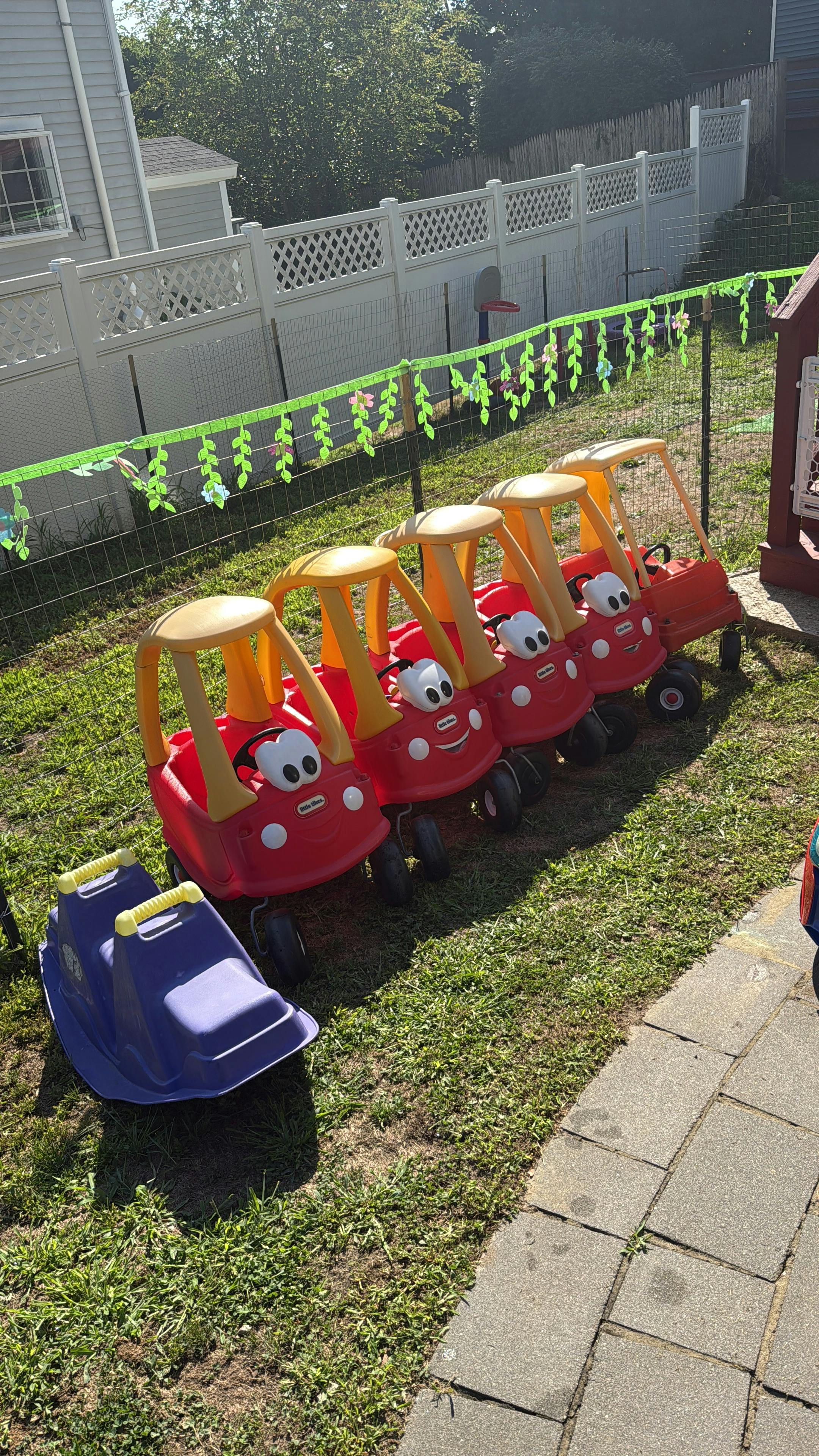 A line of toy cars on a lawn