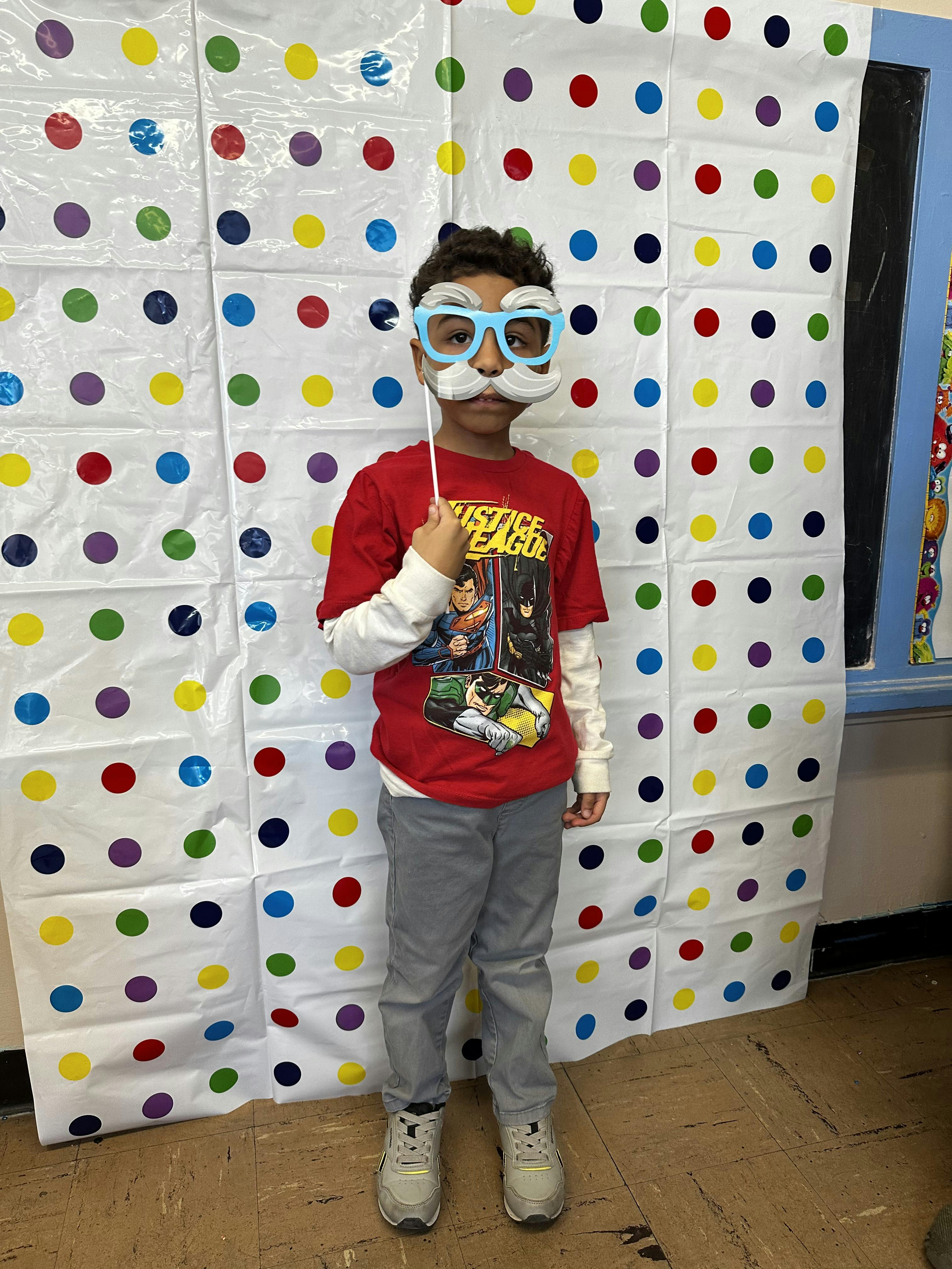 Child wearing a novelty mask with glasses and a mustache