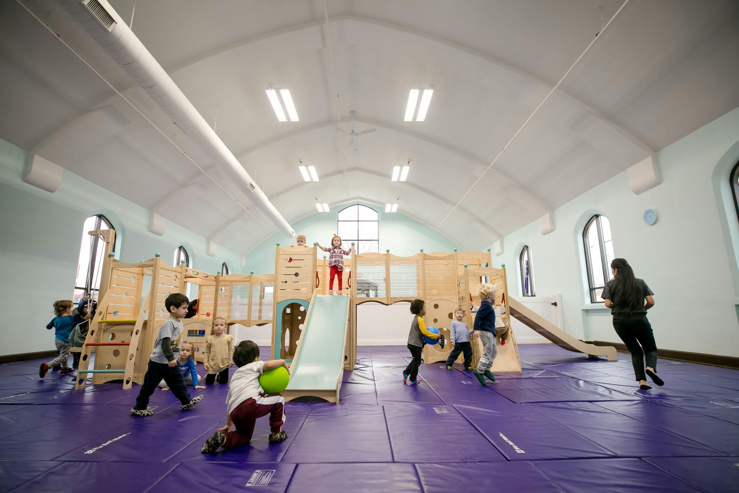 Children playing on indoor playground equipment