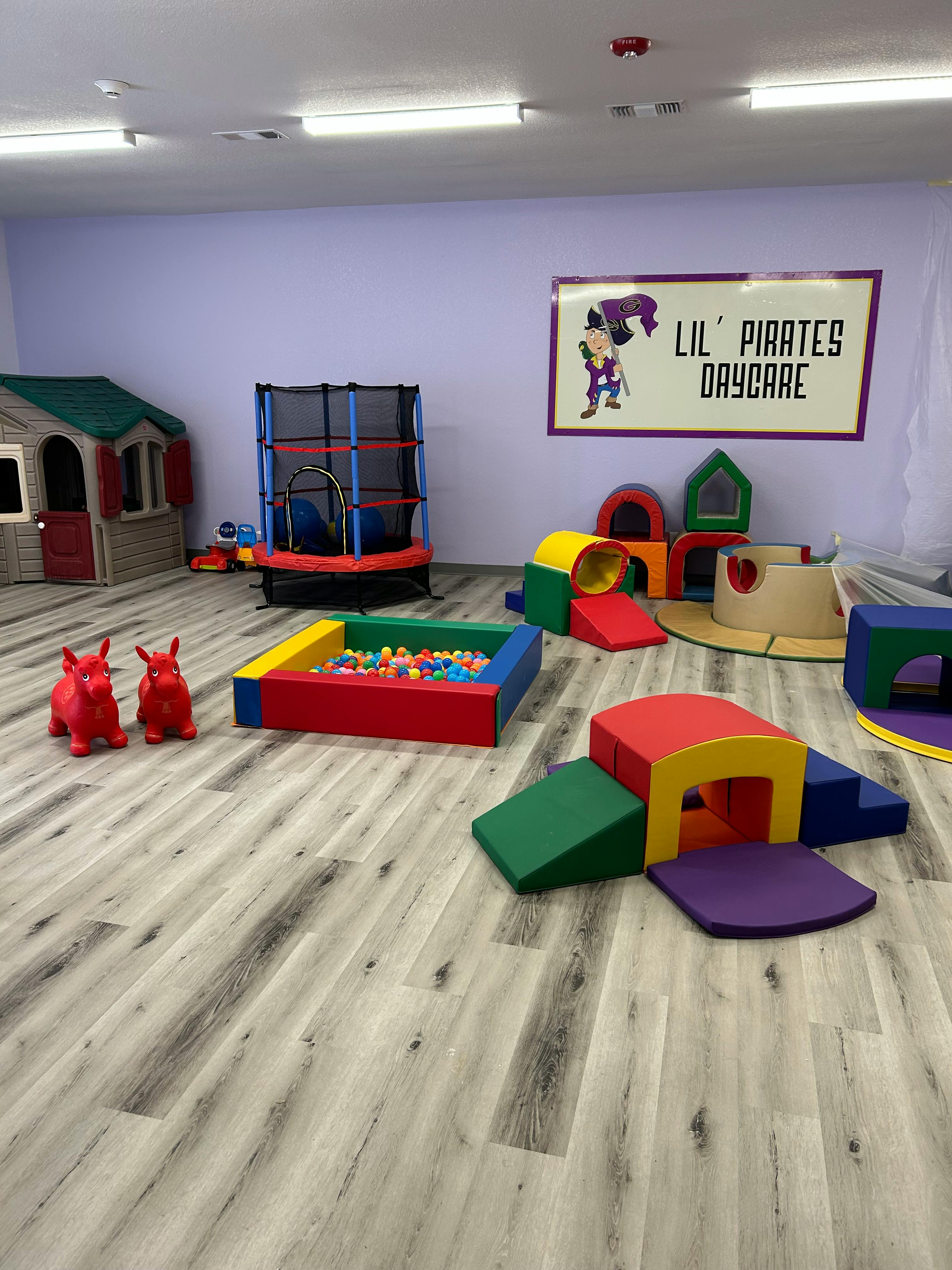Indoor play area with soft play equipment, ball pit, and trampoline