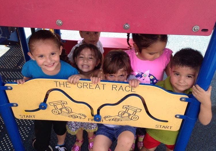 Children looking through a cutout with "The Great Race" text