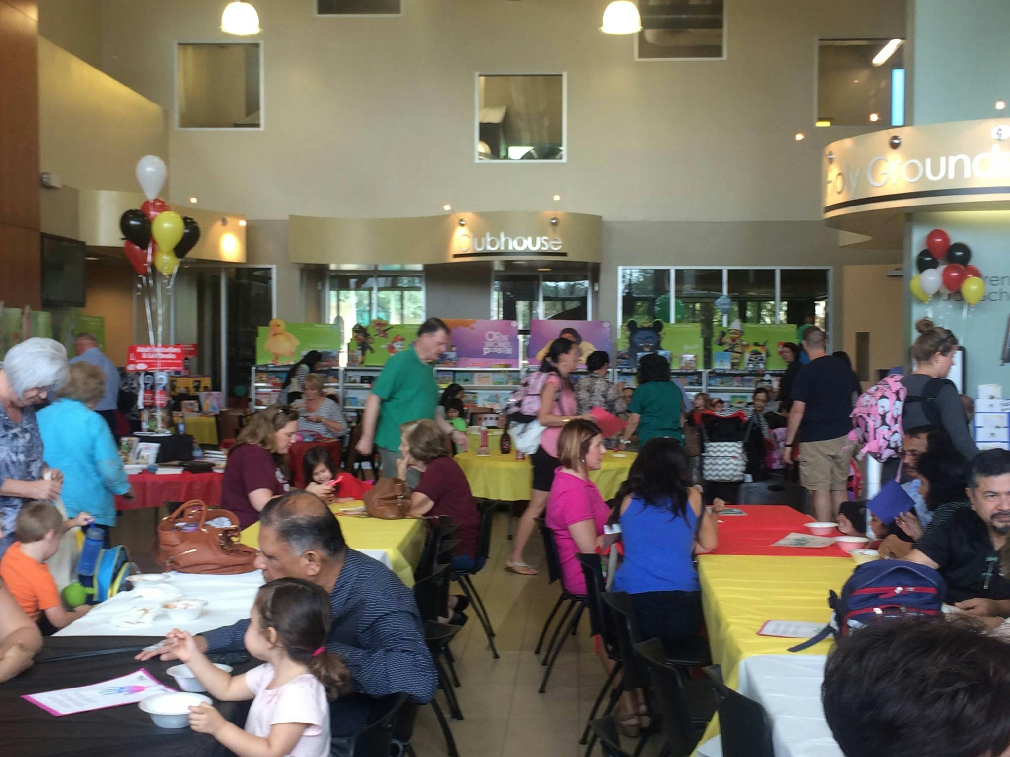 People gathered at tables in a large indoor space