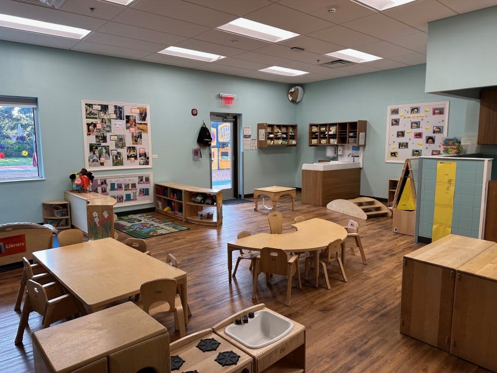 Empty colorful children's classroom with small tables and chairs