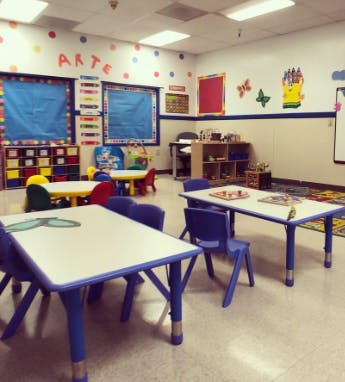 Empty classroom with small tables and chairs