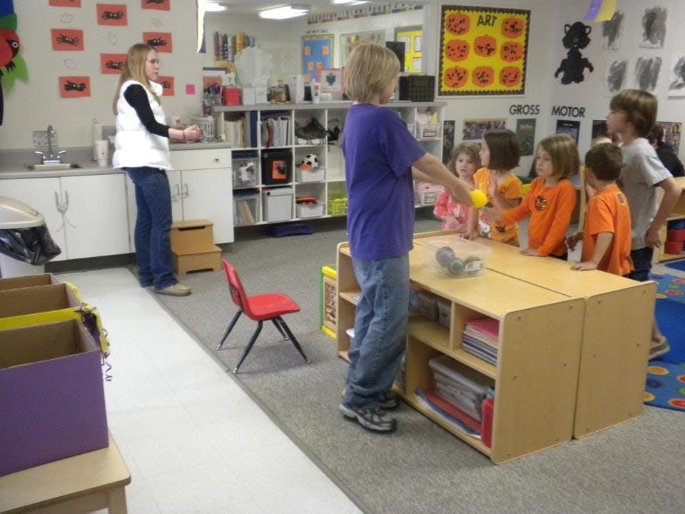 Adult and children in a classroom