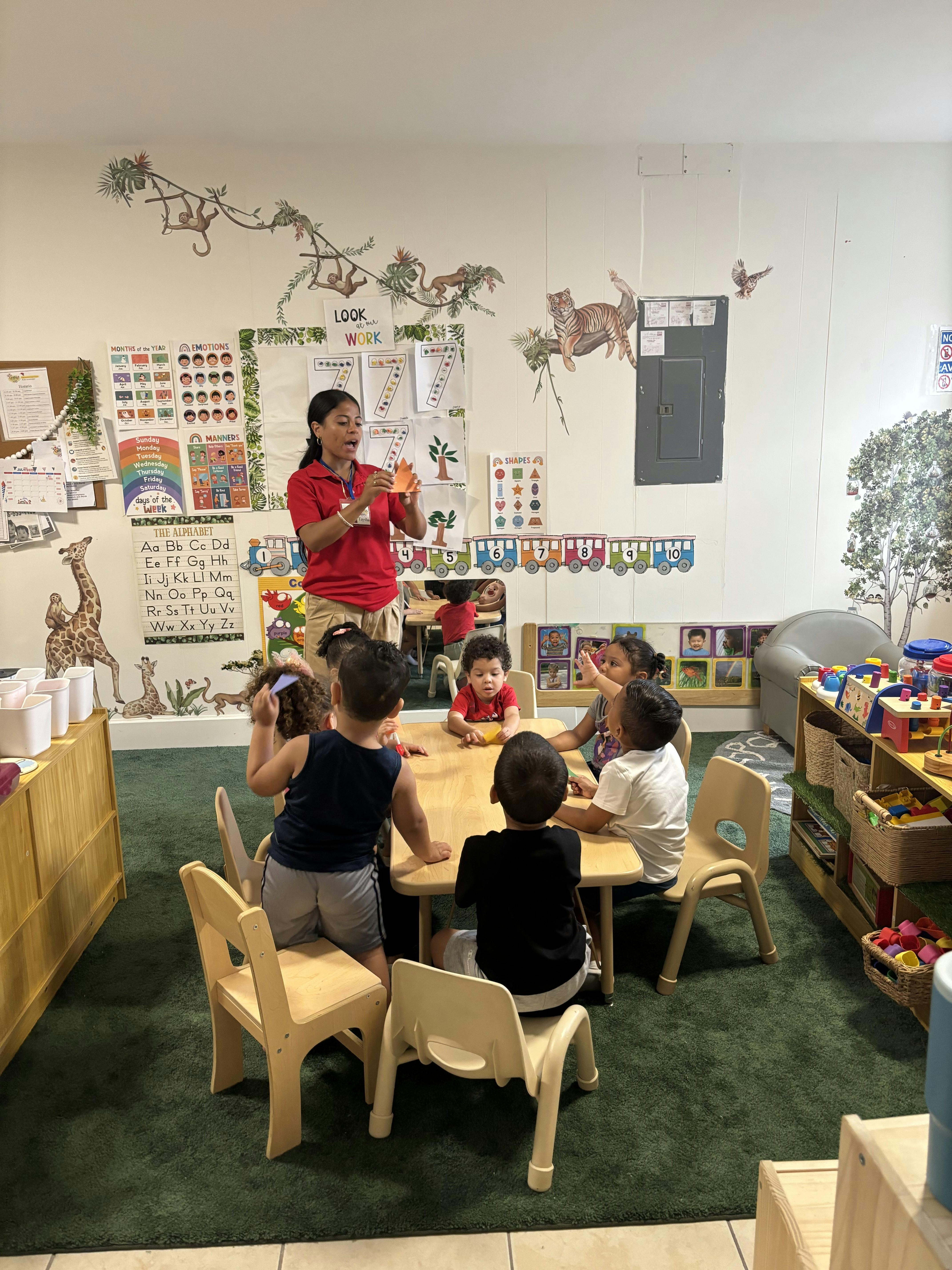 Adult teaching children in a classroom