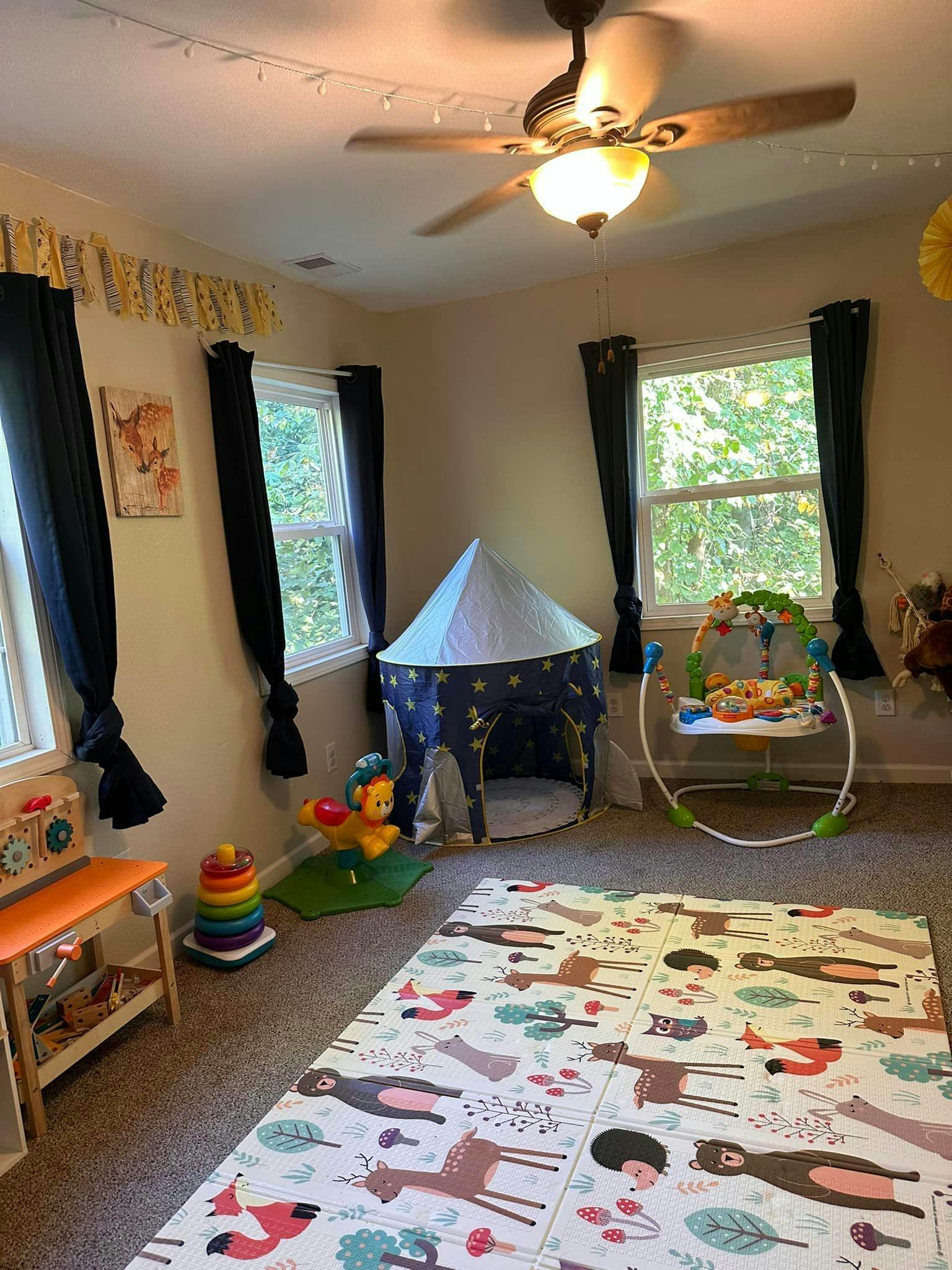 Playroom with a tent, playmat, and baby bouncer