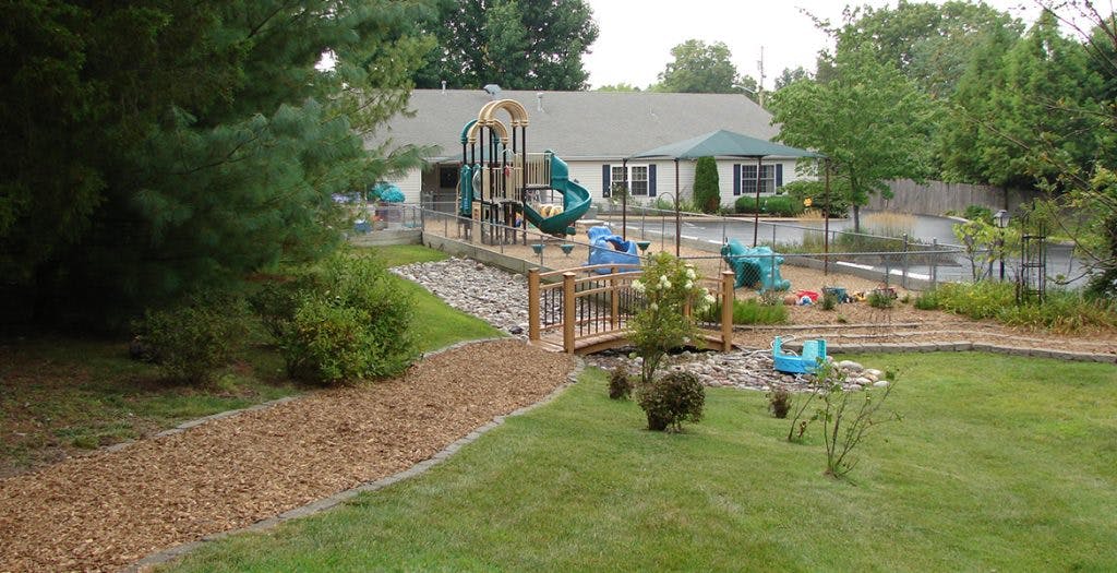 Playground with slides and swings next to a building