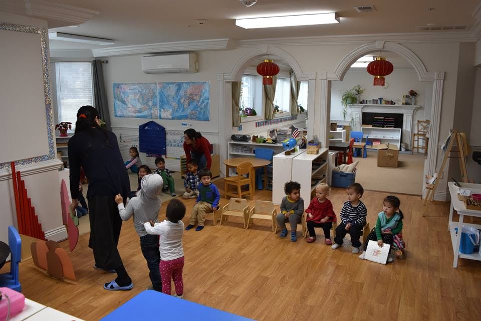 Adults and children in a classroom