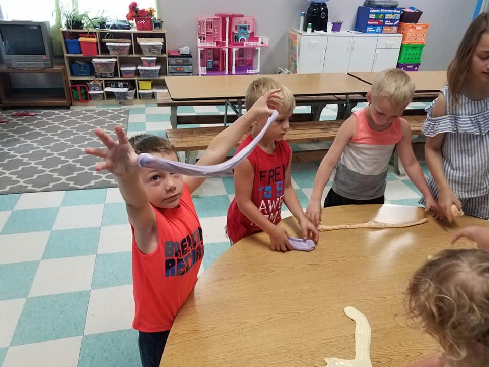 Children playing with slime at a table