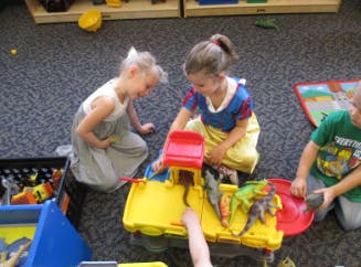 Children playing with toys on the floor
