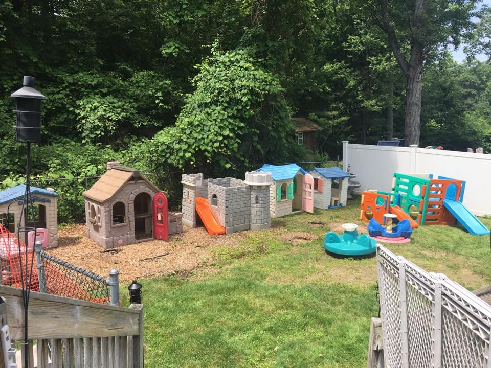 Outdoor play area with playhouses, castles, and slides