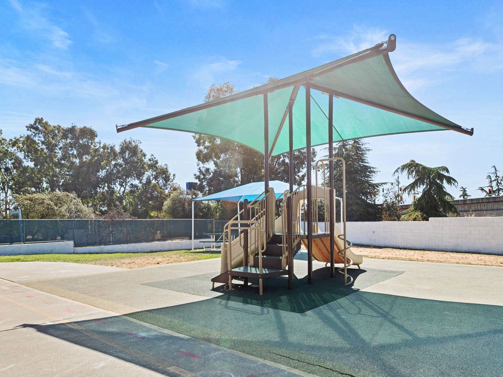 Playground equipment with a green sunshade