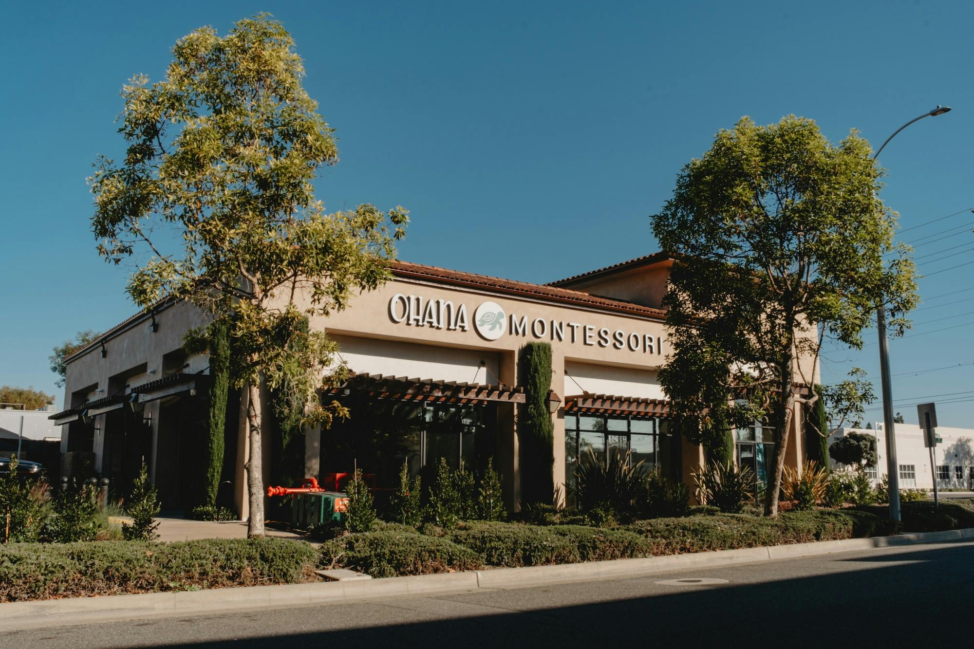 Ohana Montessori building with green landscaping along a street