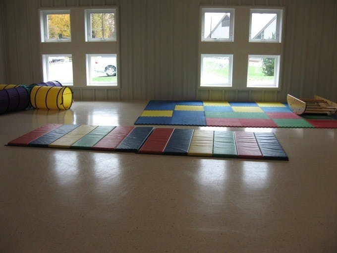Gymnasium with colorful mats and play tunnels