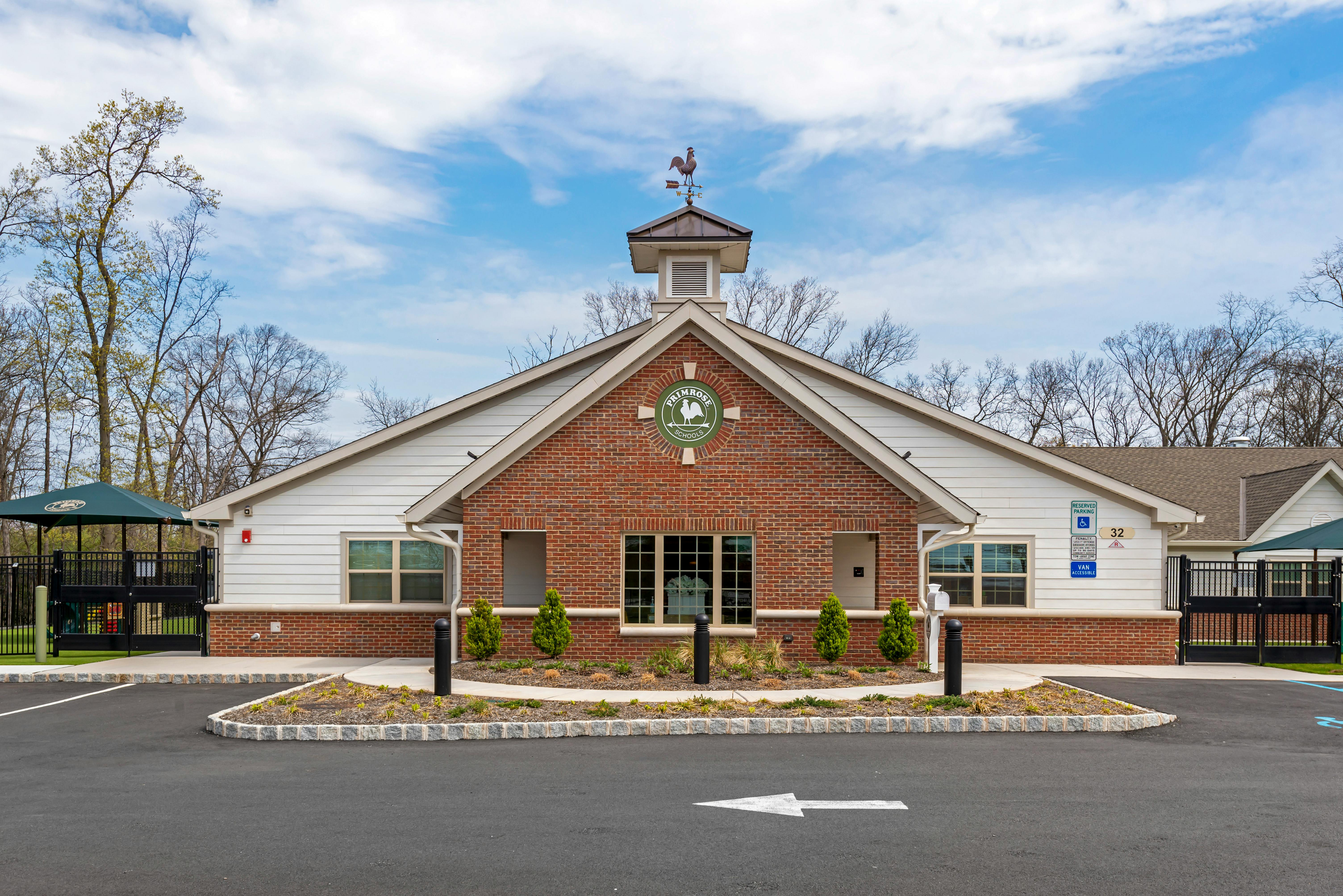 Front exterior of a Primrose Schools building with a playground nearby
