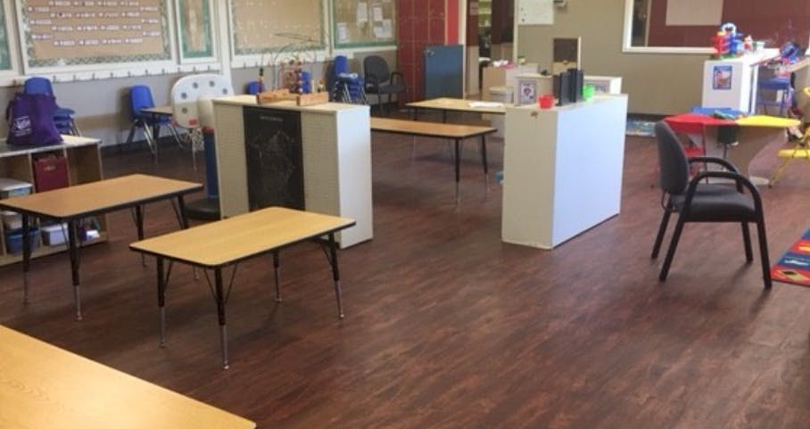 Empty classroom with small tables and chairs
