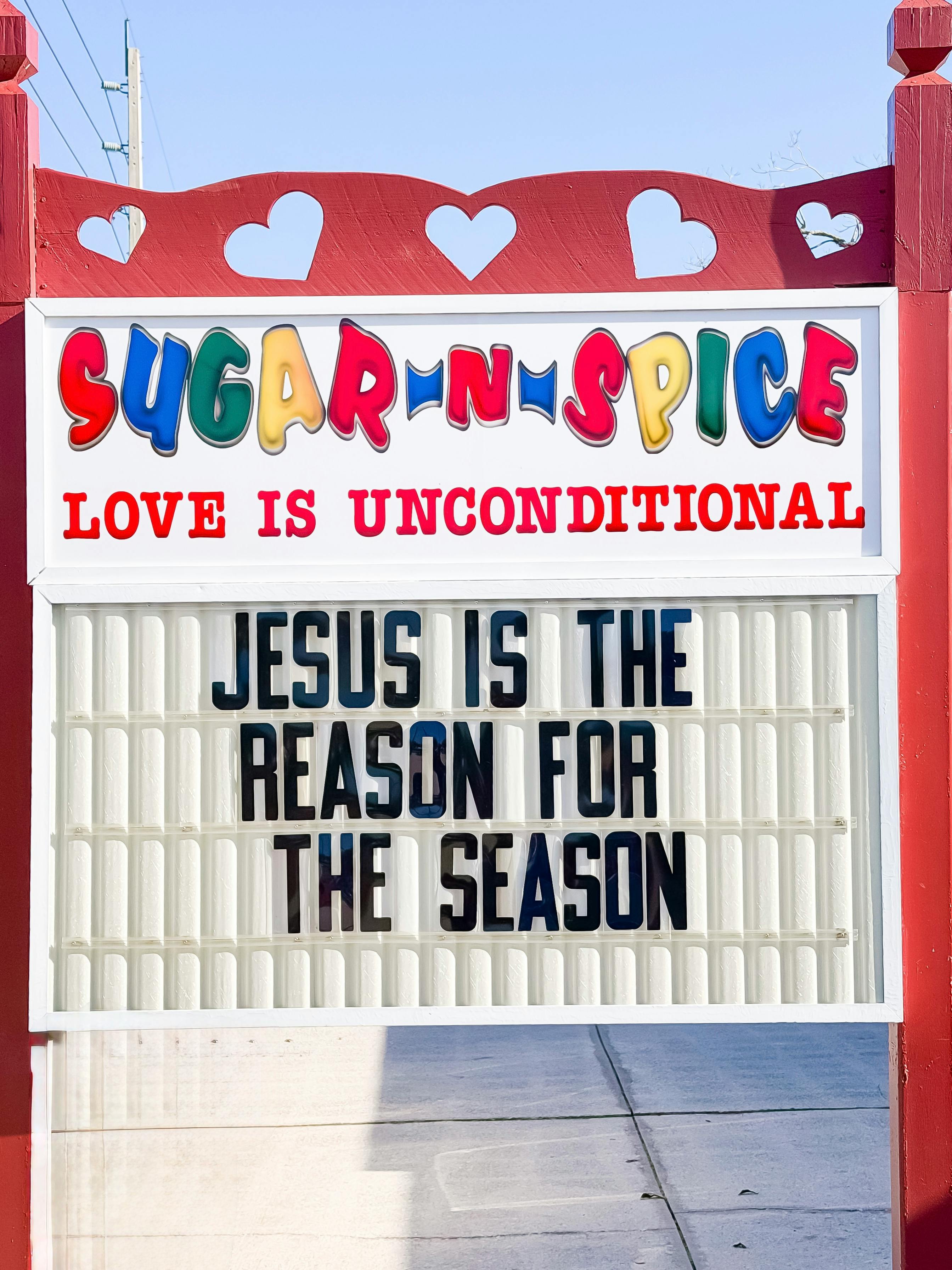 Sign reading Sugar N Spice Love Is Unconditional and Jesus is the reason
