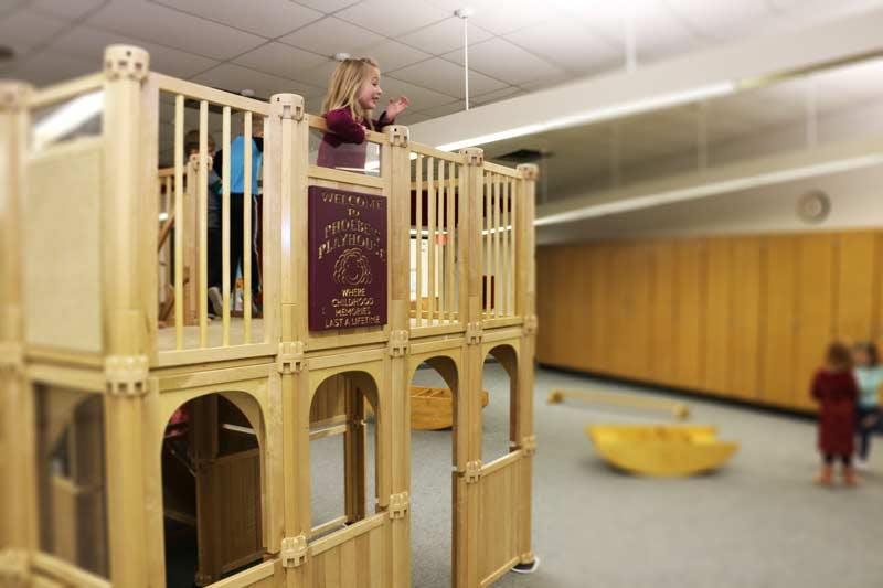Child on top level of indoor play structure