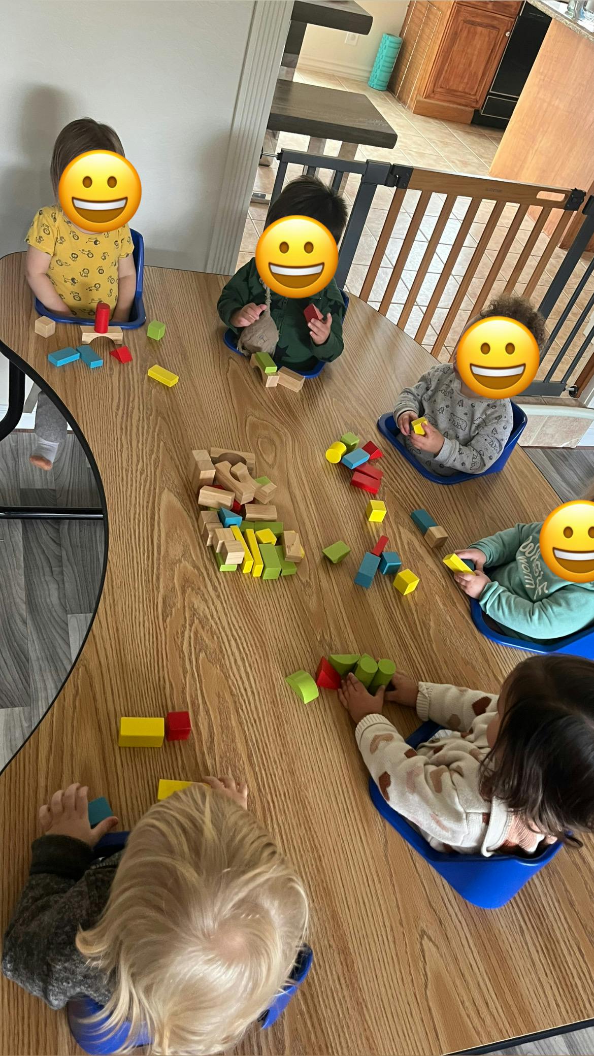 Children playing with building blocks on a wooden table
