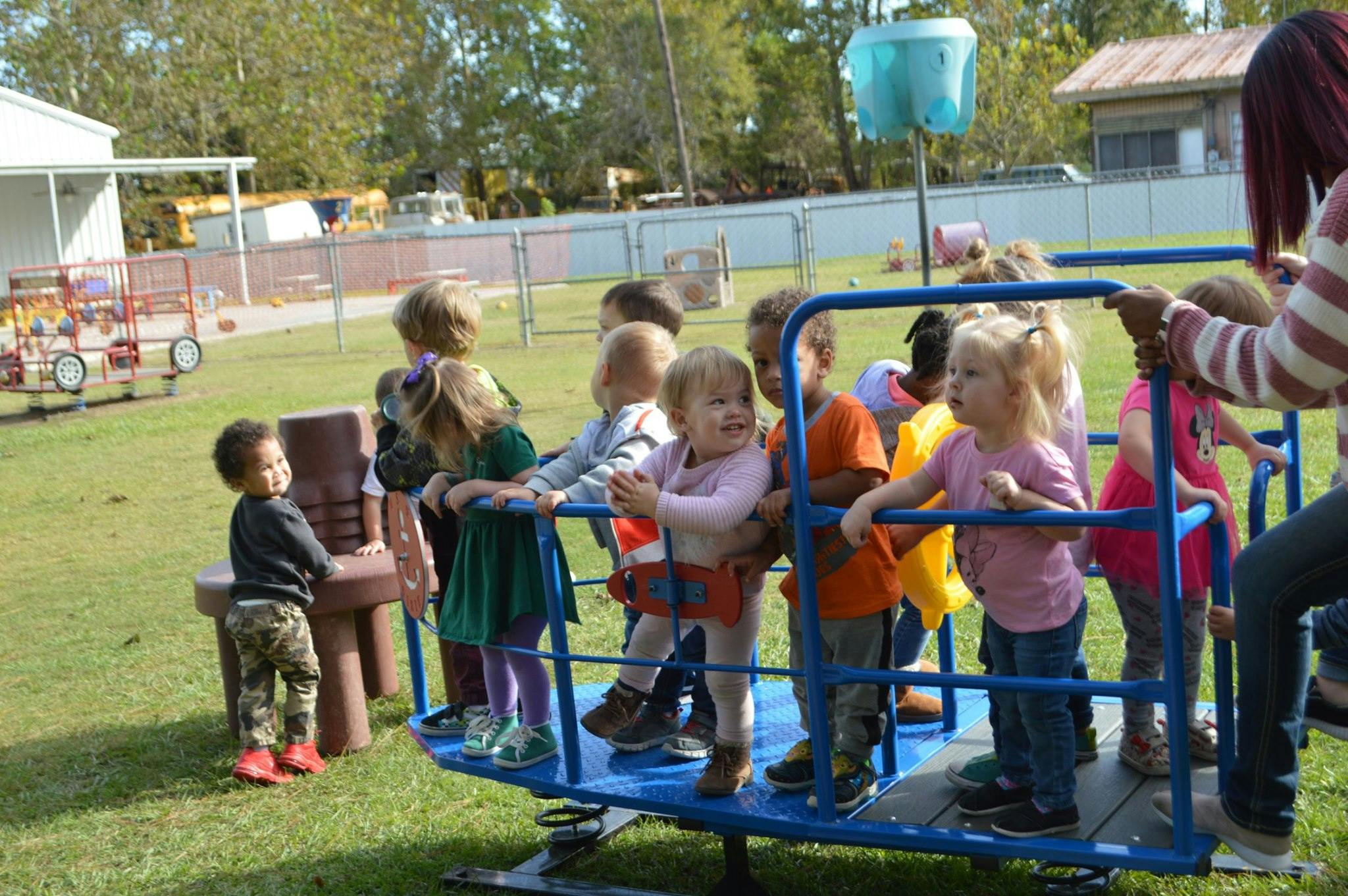 Children playing on a playground merry-go-round