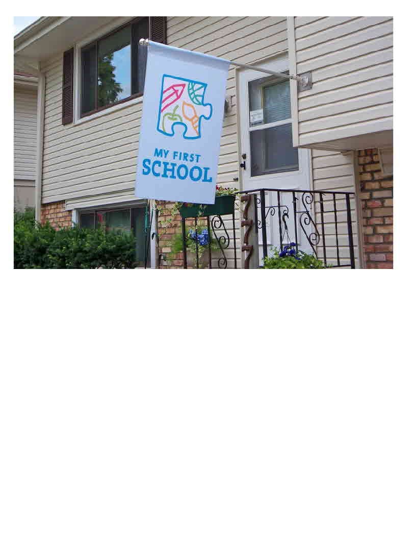 Flag with puzzle piece logo and text "MY FIRST SCHOOL" hanging from a building