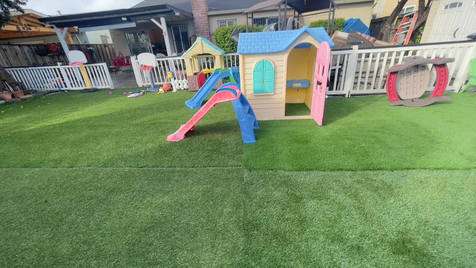 Playhouse and slide on artificial grass