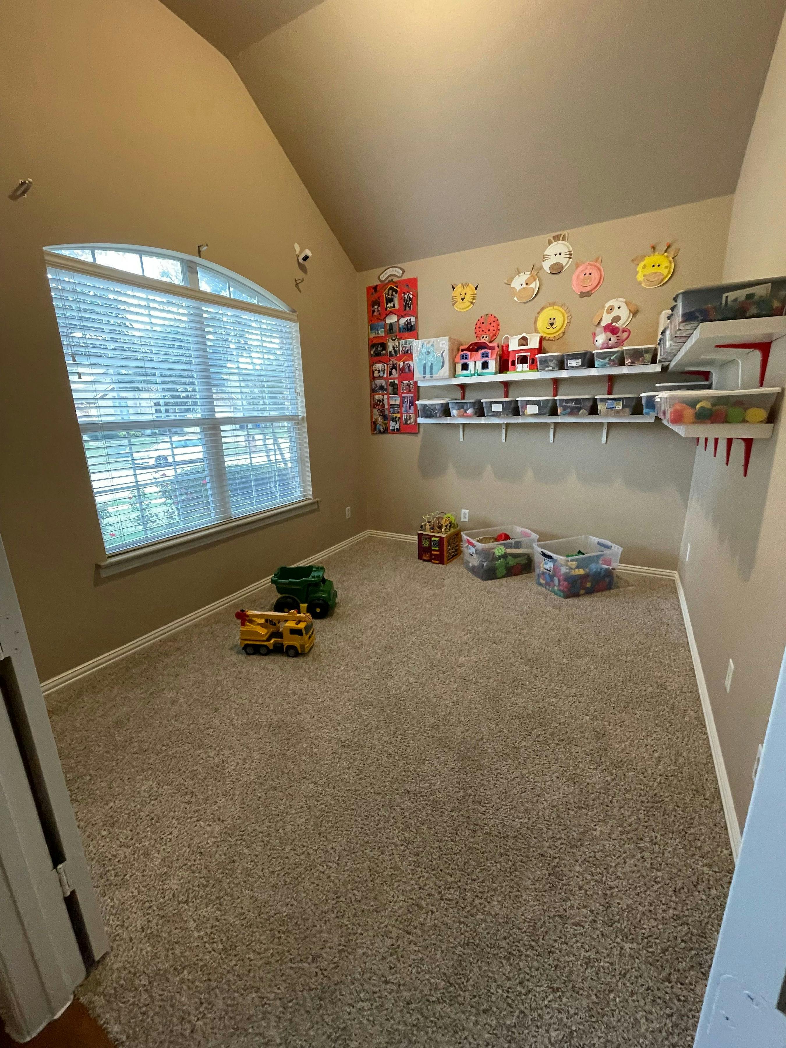 Playroom with toys on the floor and shelves