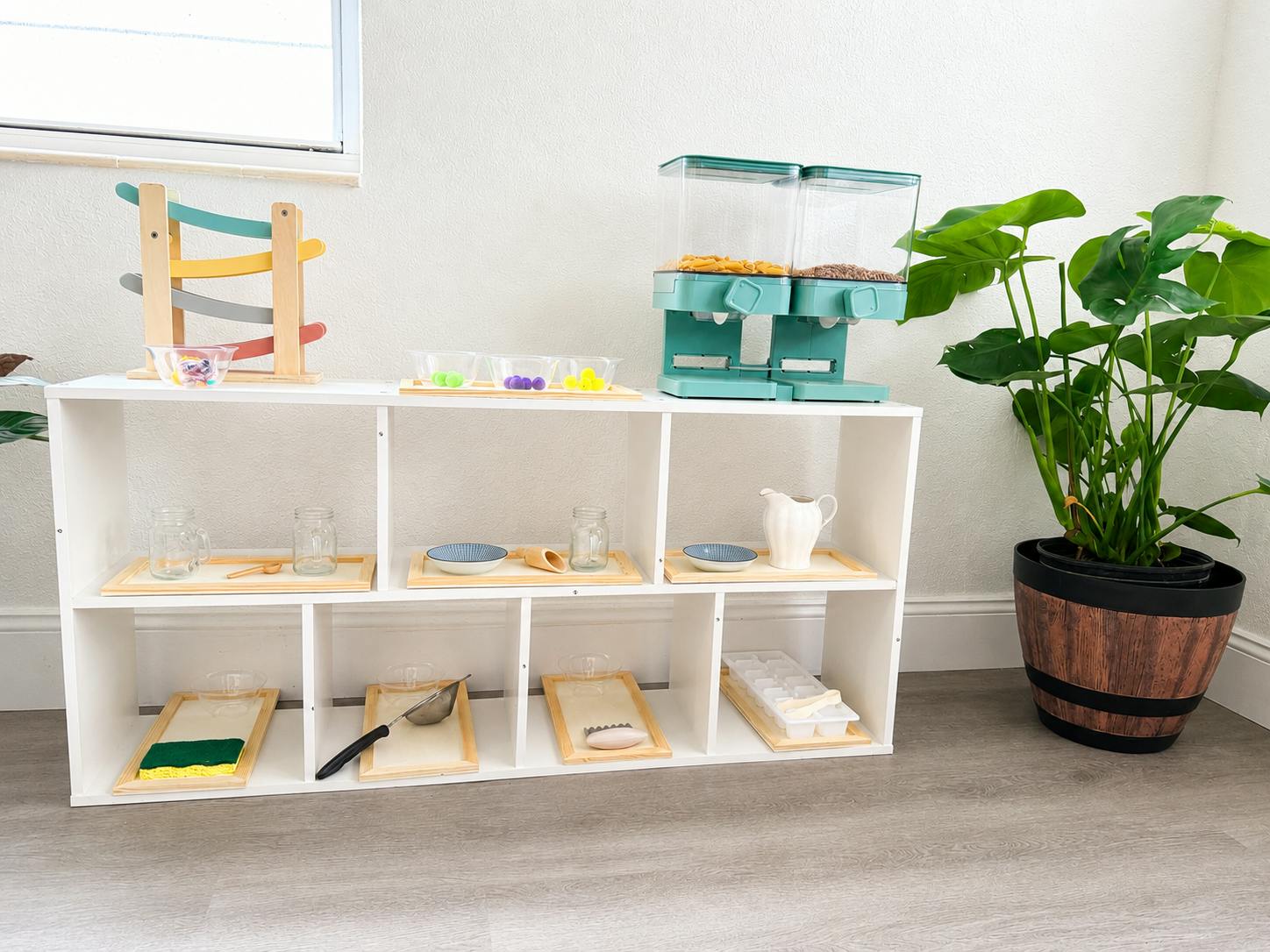 White storage shelving unit with assorted children's learning activities