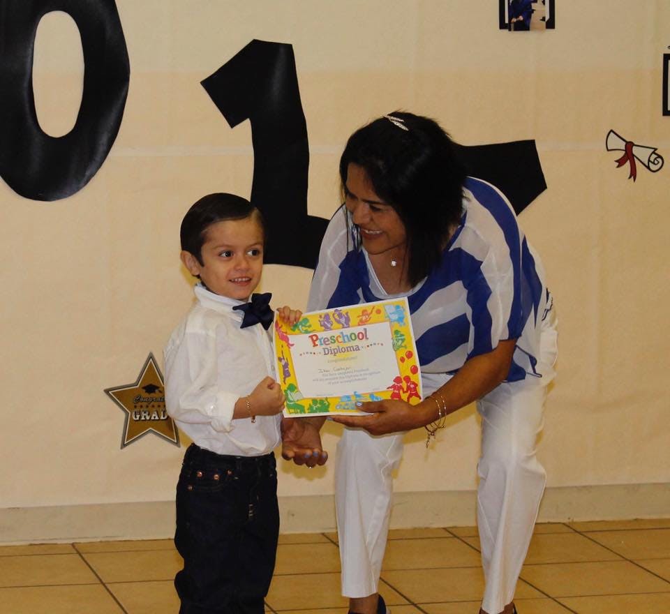 Person presenting a certificate to a child
