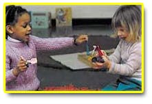 Two children playing with small toys
