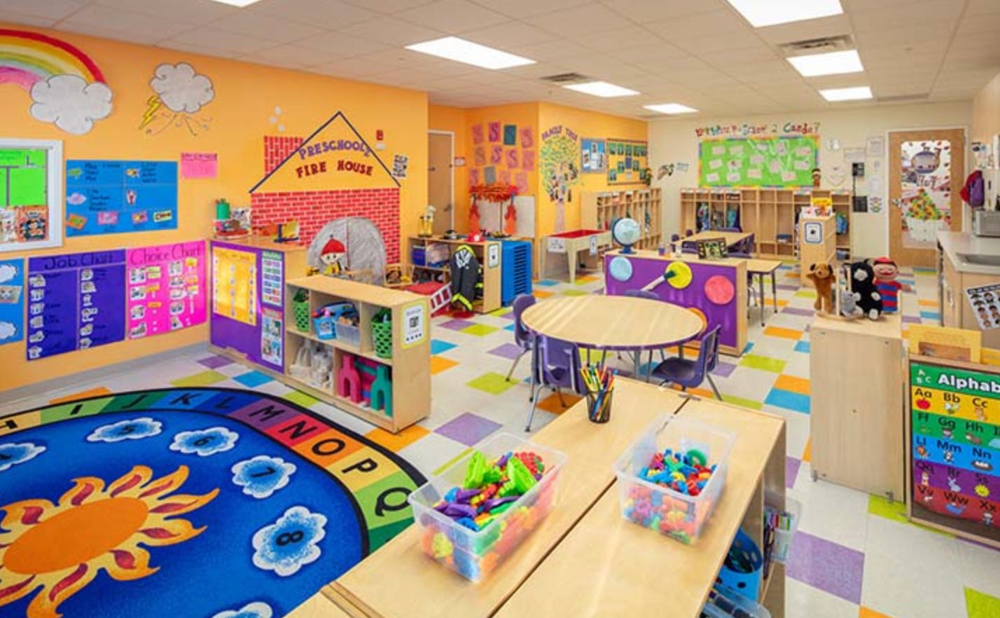 Colorful classroom with tables, chairs, and play areas