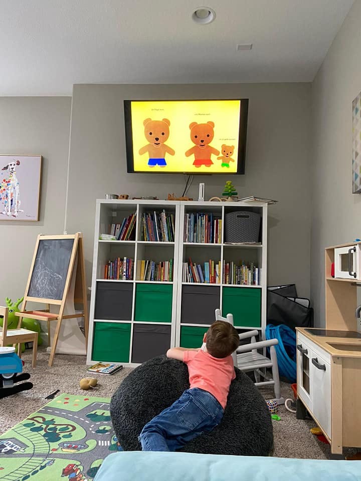 Child watching cartoon bears on a television