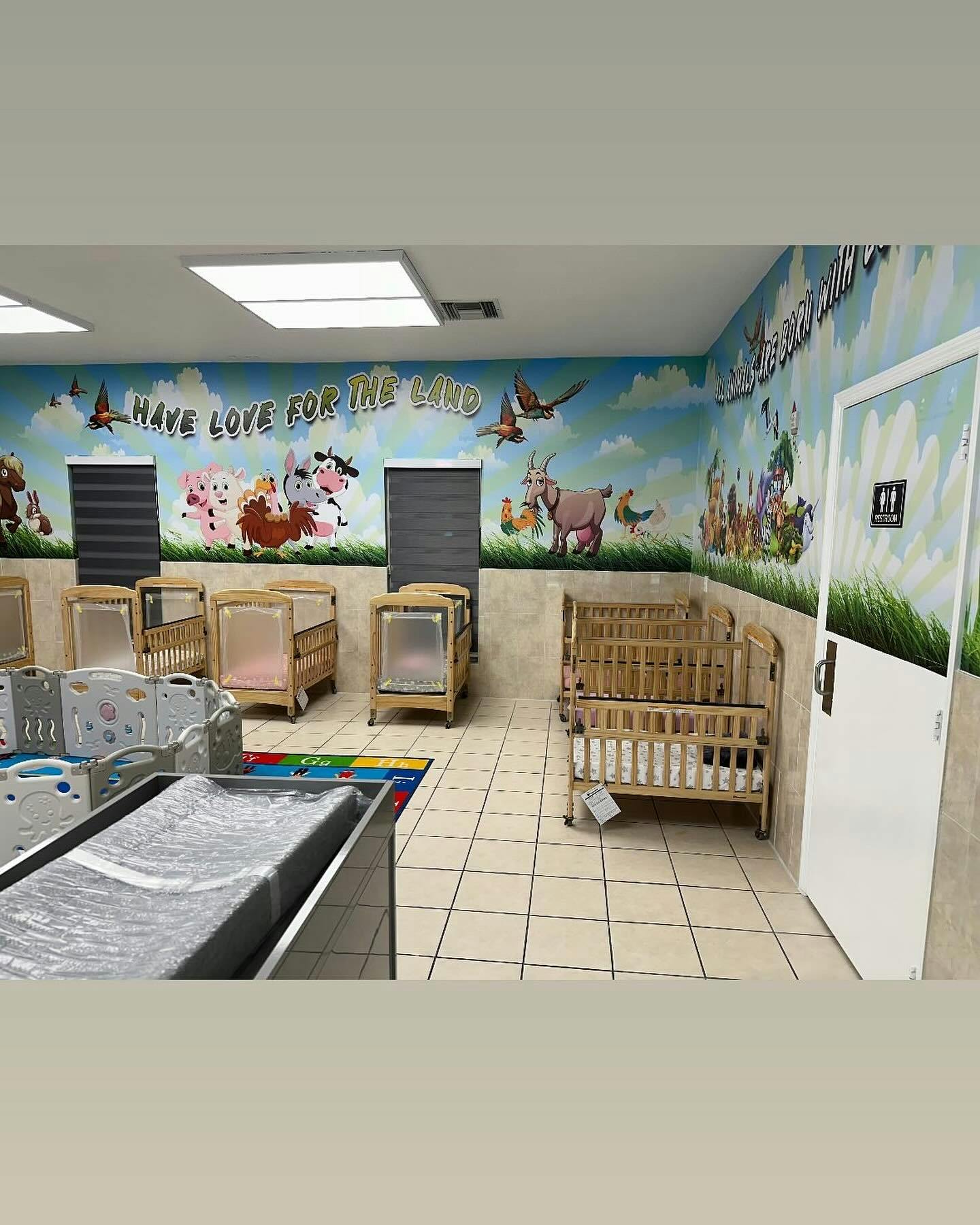 Nursery room with multiple cribs and changing table