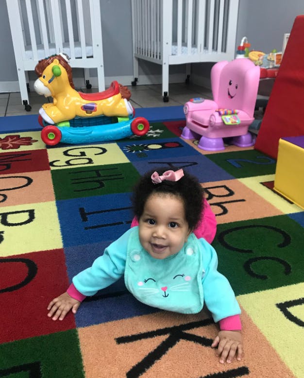 Child crawling on an alphabet rug