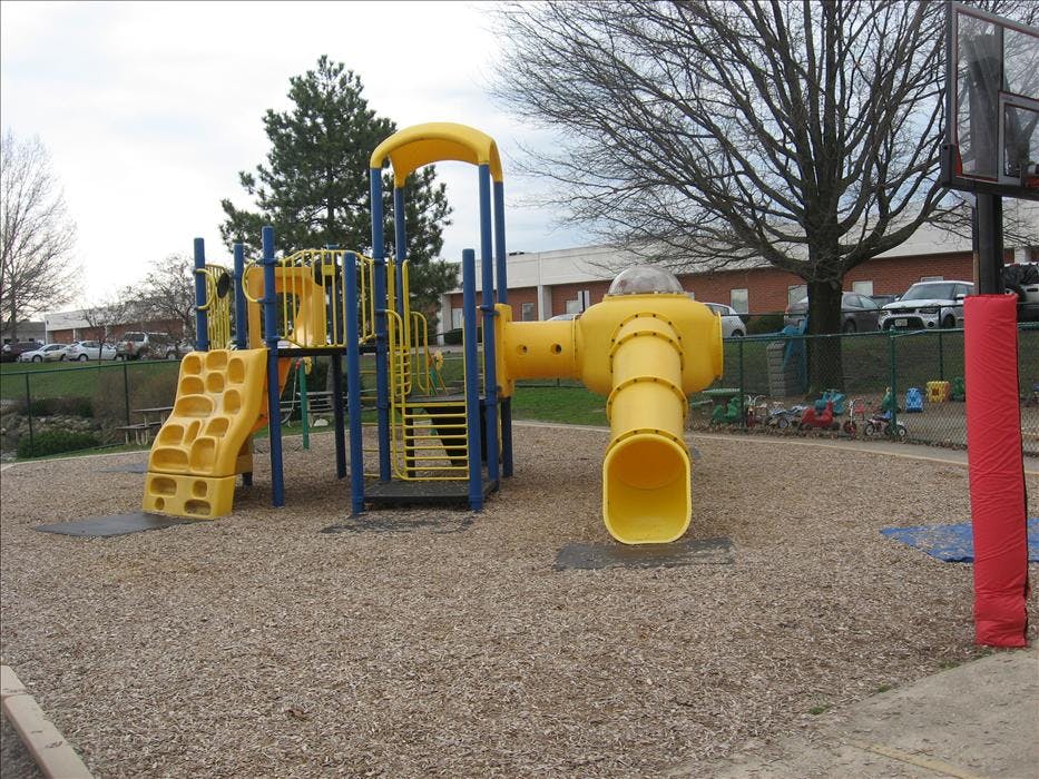 Yellow and blue playground equipment on wood chips