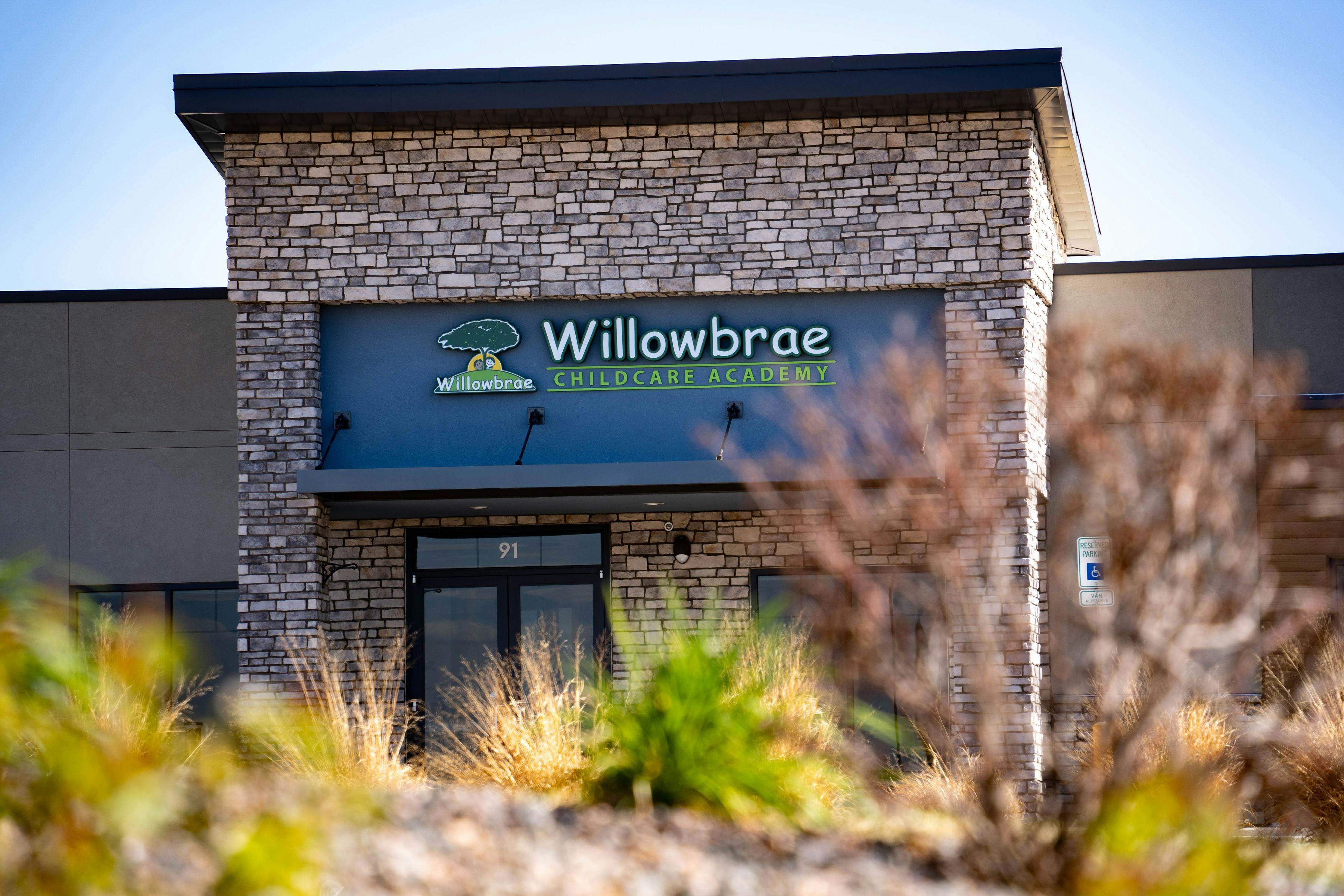 Entrance to a building with a "Willowbrae Childcare Academy" sign
