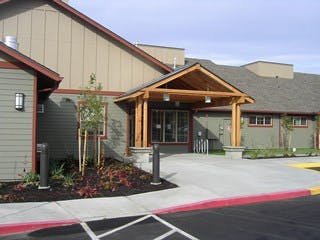 Building exterior with covered entrance and paved driveway