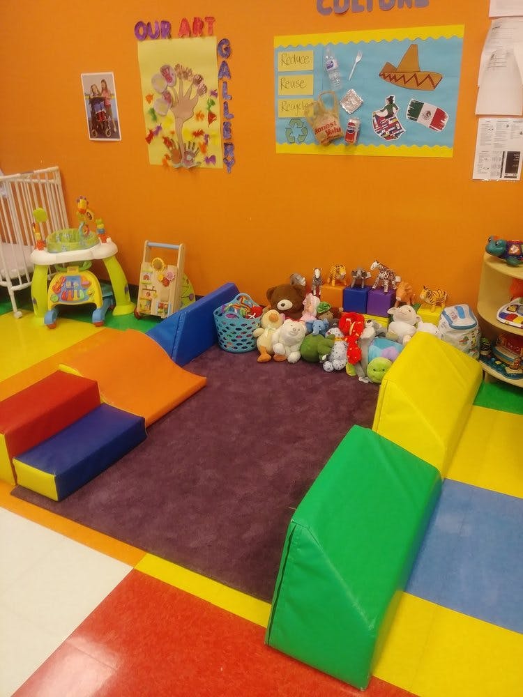 Playroom with soft play equipment, toys, and wall decorations