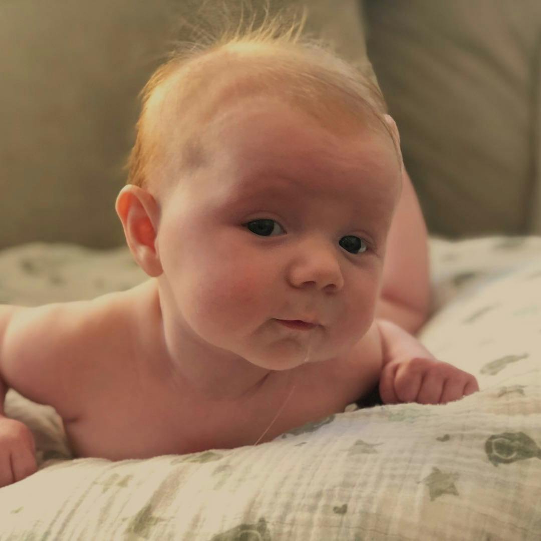 Baby doing tummy time with drool on chin