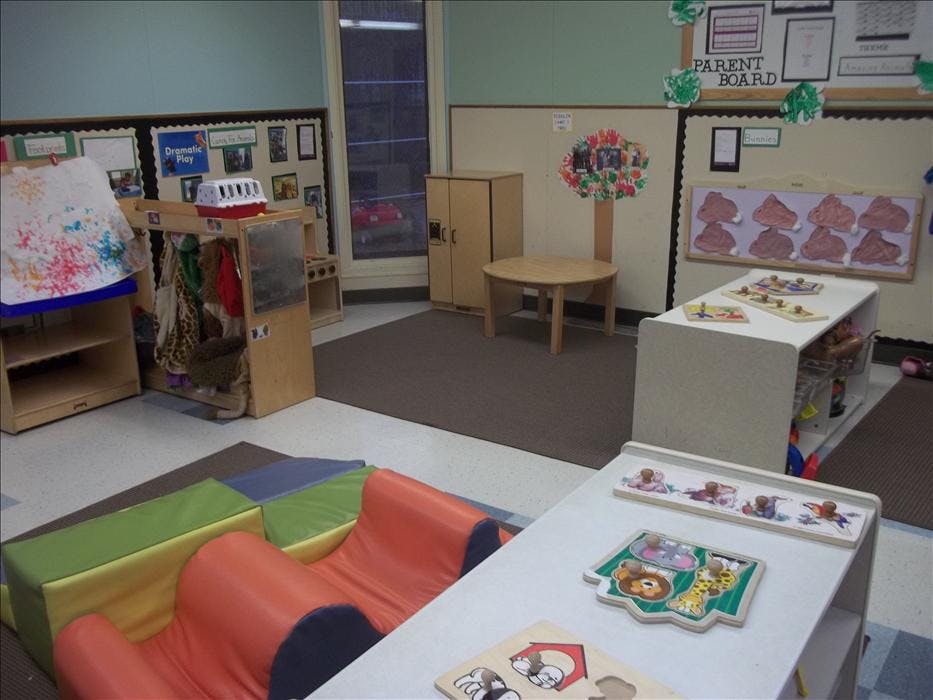 An empty children's play area with various toys and furniture