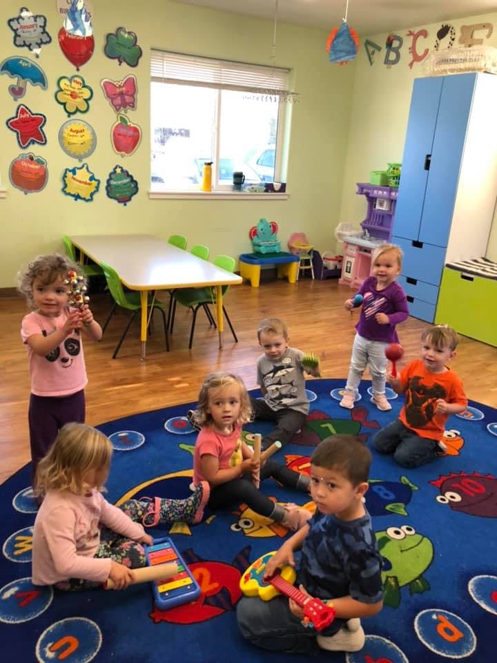 Children playing with musical toys in a classroom