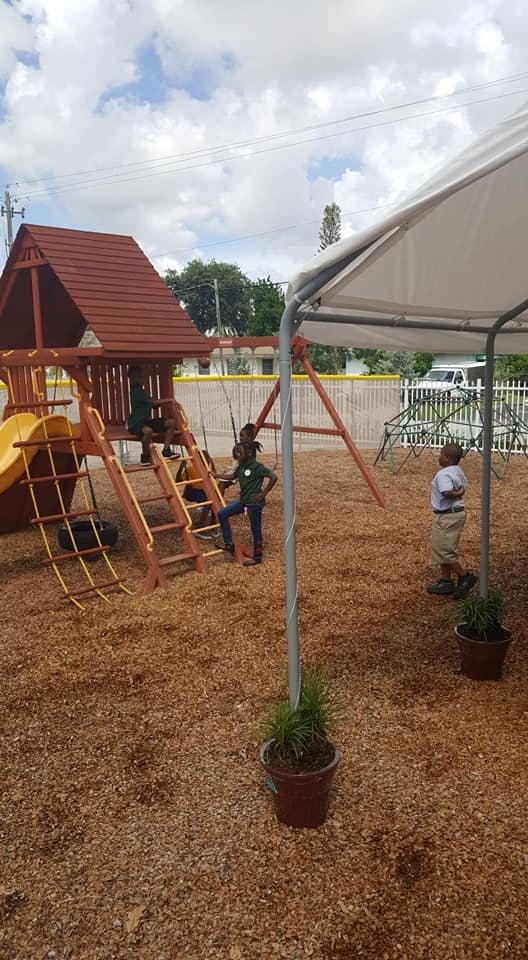 Children playing on a wooden playground structure