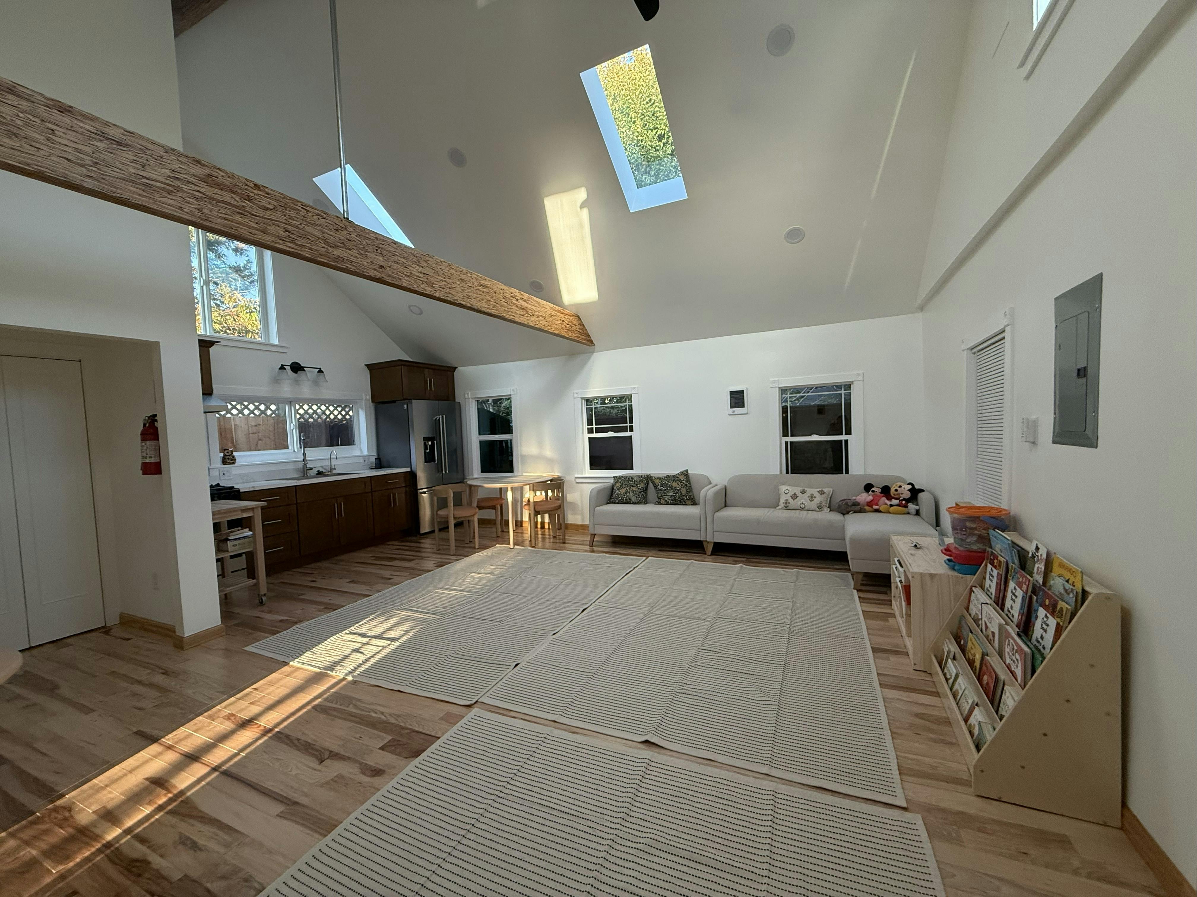 Open concept living space with kitchen, dining area, and living room